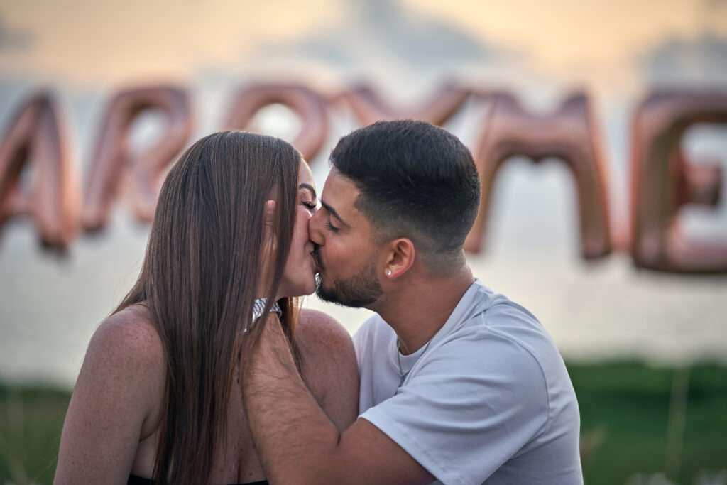 engaged couple kissing sunset marriage proposal surprise