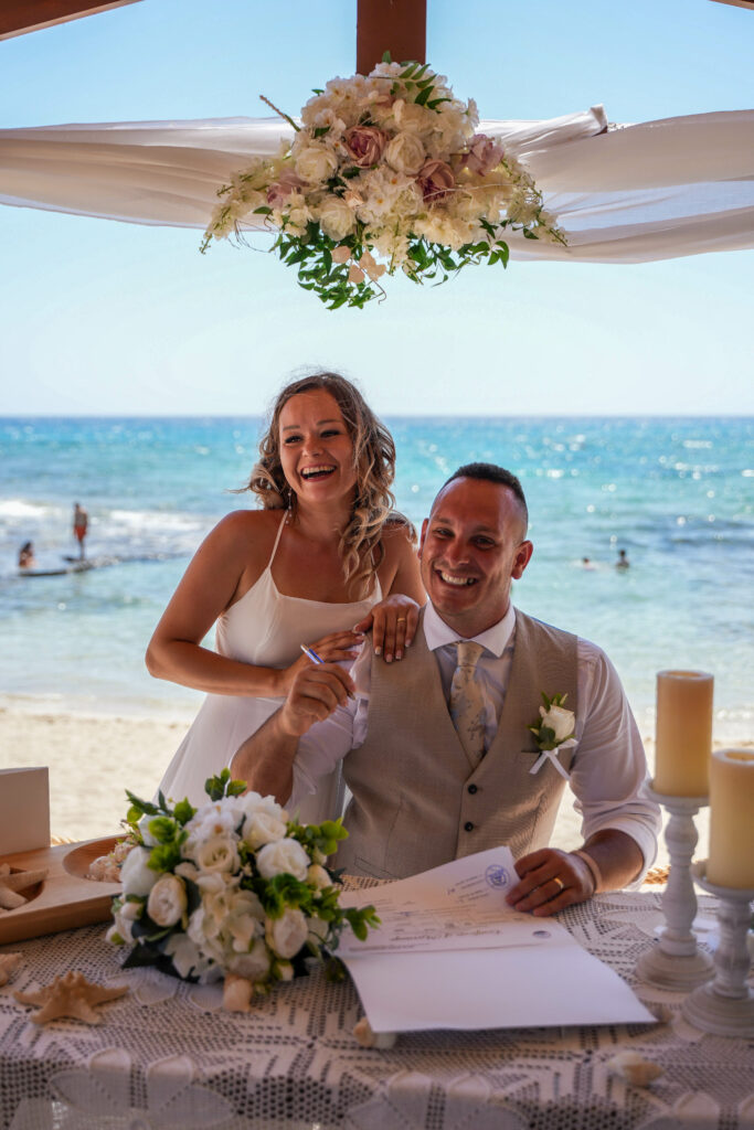 couple signing marriage certificates Ammos Kampouri Ayia Napa beach wedding Cyprus