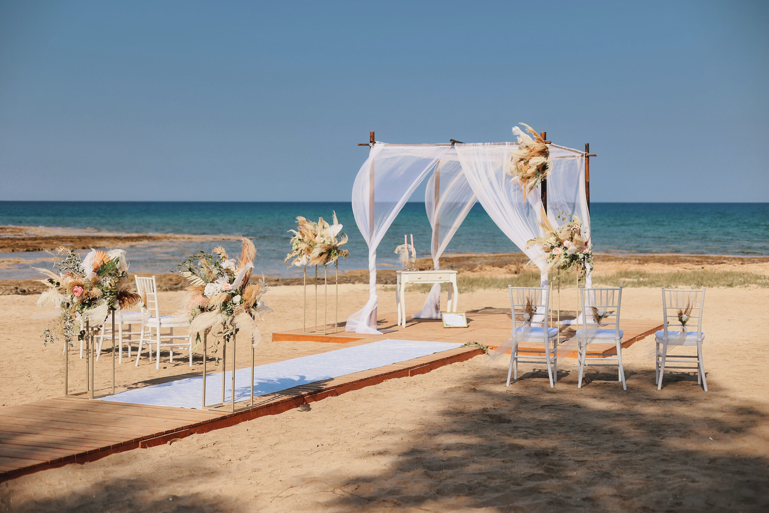 Intimate elopement wedding ceremony at Ayia Triada beach Cyprus with beautiful boho decorations