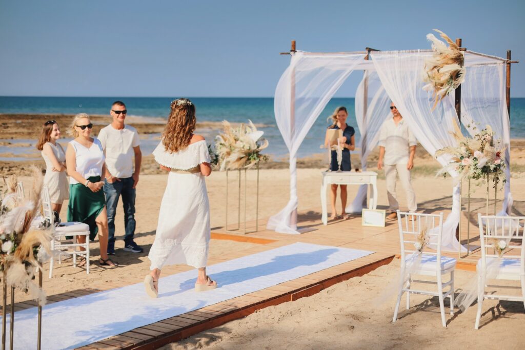 Bride walking down the isle Ayia Triada Cyprus wedding beach ceremony