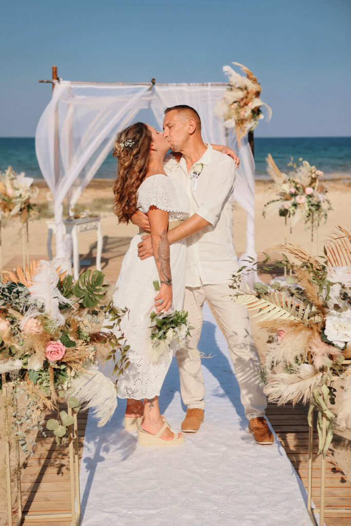 married couple kissing at the Ayia Thekla beach Cyprus
