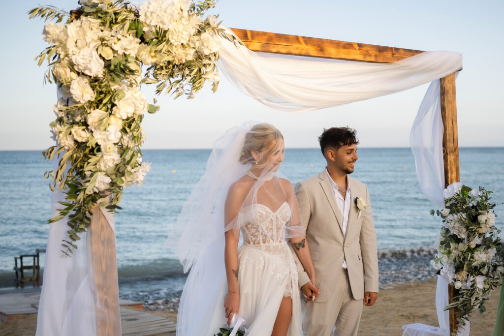 green white floral wooden arch beach wedding ceremony Cyprus