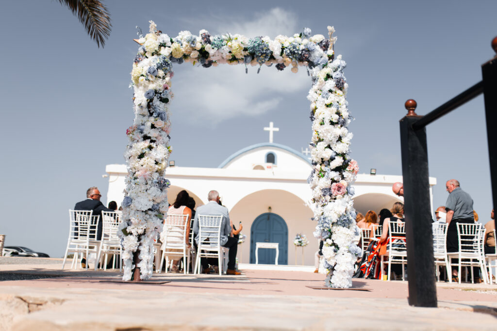 blue white and green floral wedding arch Ayia Thekla church