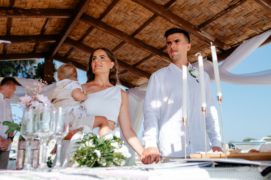 09-09-2024 (36 of 168) Wedding couple holding hands during their beach ceremony near Ayia Napa, Cyprus, exchanging vows in a serene and intimate atmosphere.