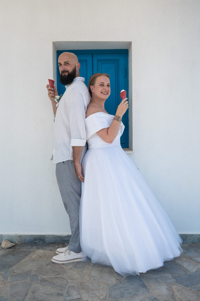 74101258_www.happyimagescyprus.com just married couple having fun eating ice cream during their wedding photoshoot at Ayioi Anargiroi Church near Ayia Napa in Cyprus