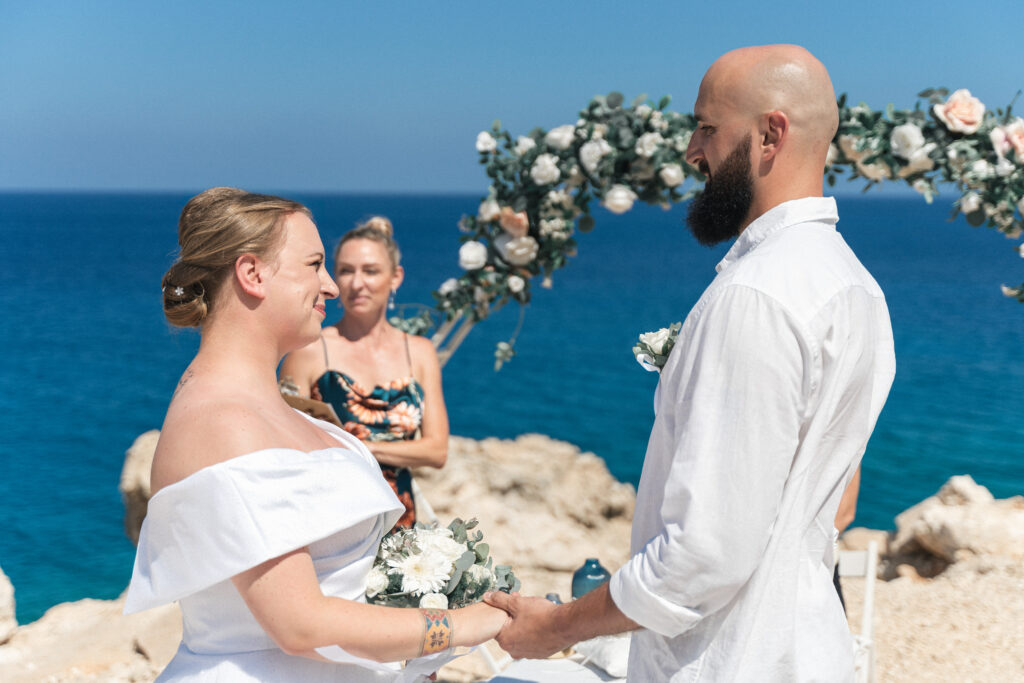 74207637-Edit_www.happyimagescyprus.com beautiful couple exchanging their wedding vows during private ceremony by the sea near Konnos Bay in Cyprus