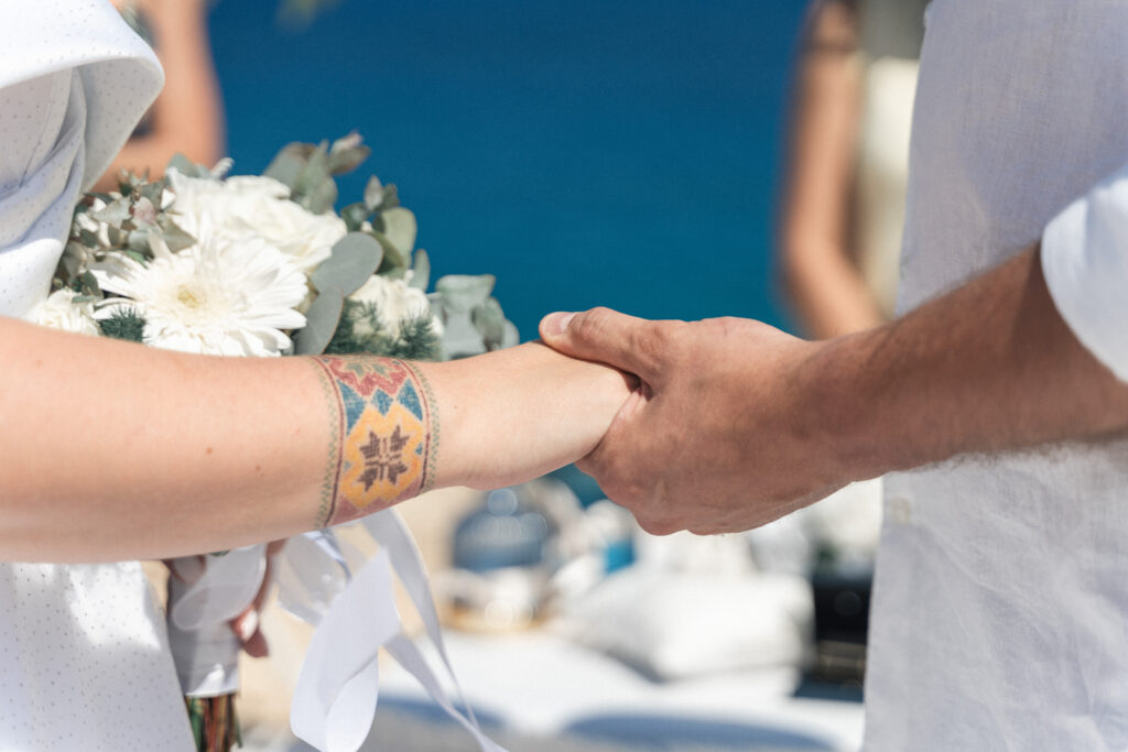 74207648_www.happyimagescyprus.com wedding couple holding hands during their romantic intimate beach ceremony near Protaras Cyprus