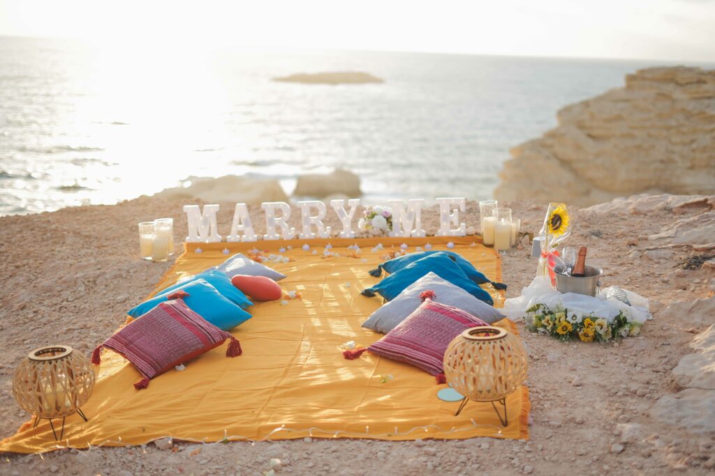 romantic sun set proposal in Paphos including yellow color set and marry me sign