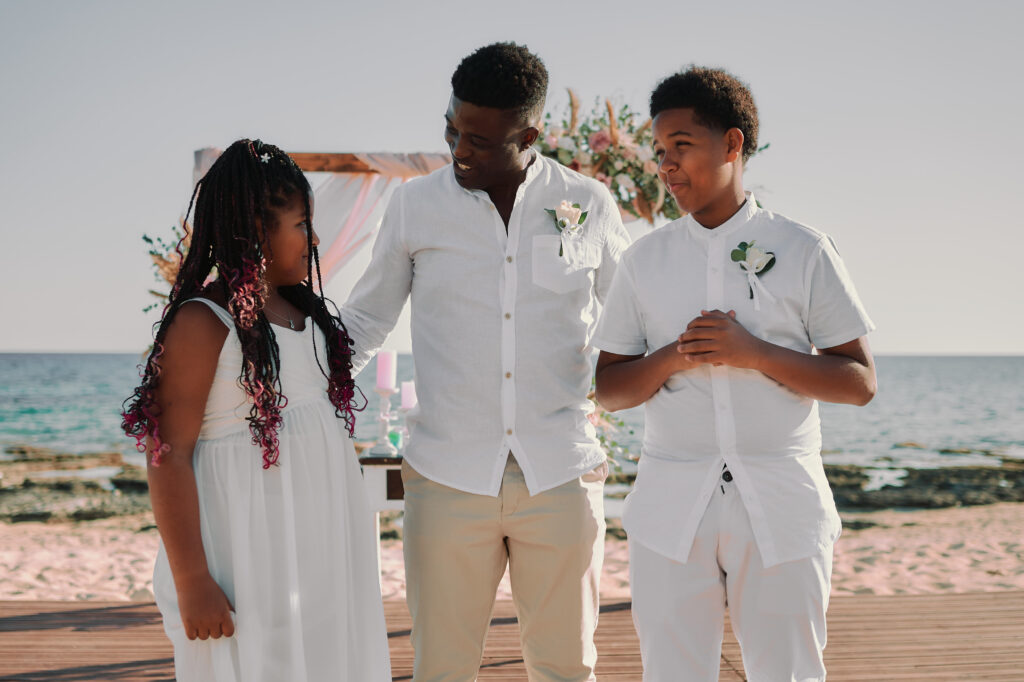 groom and his kinds are having fun during wedding family photoshoot at Sirens Beach near Ayia Napa in Cyprus