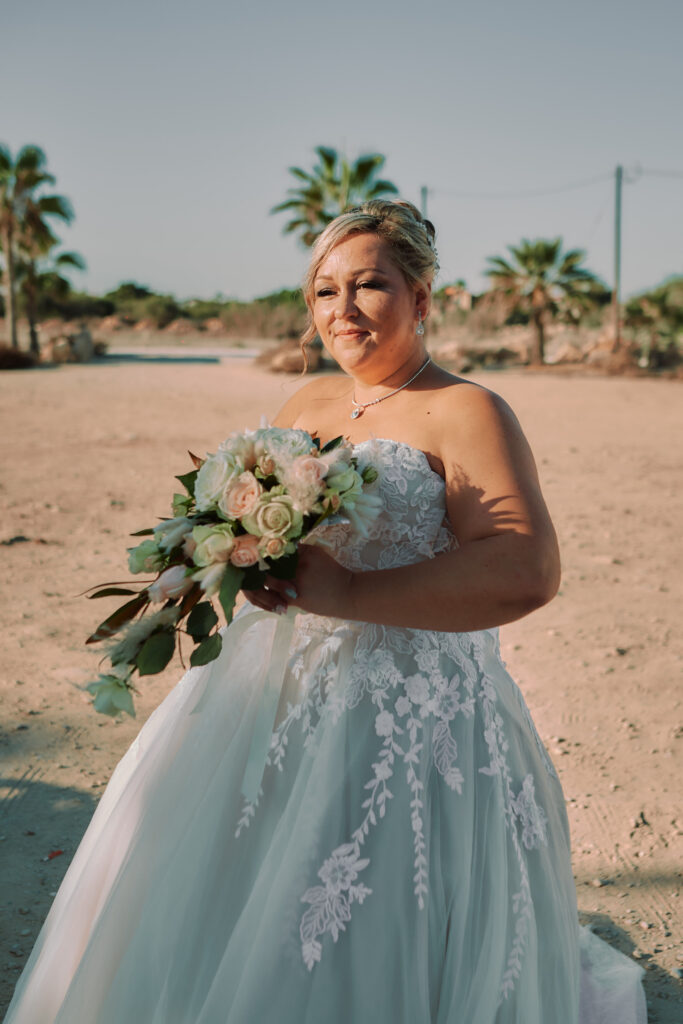 bride holding beautiful fresh flower bouquet looking forward to marry the love of her life in Cyprus