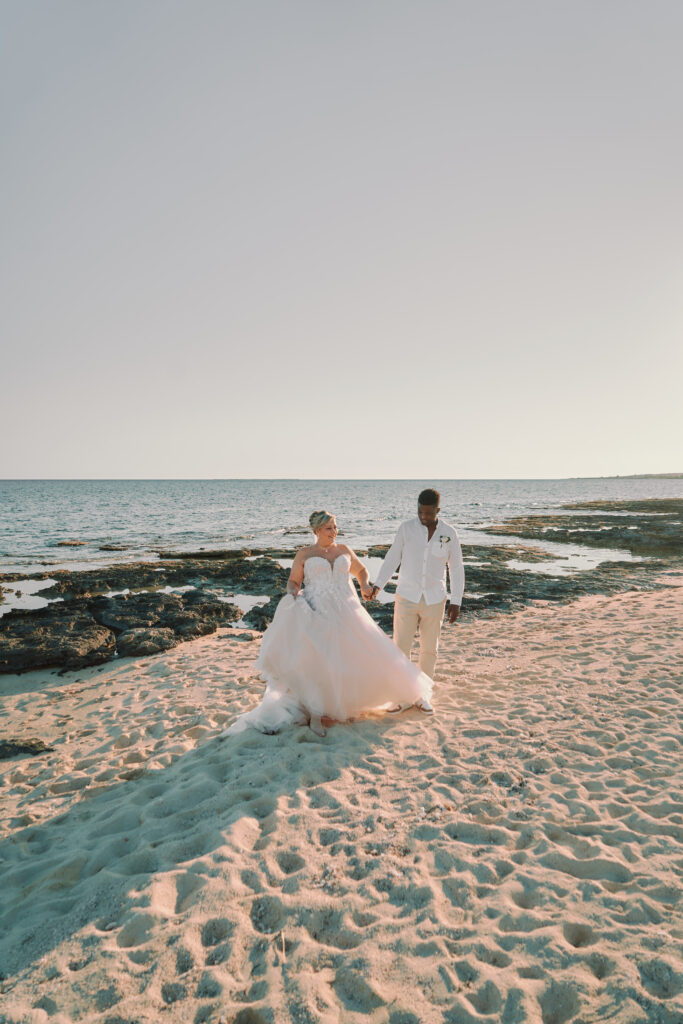 bride and groom enjoying their sunset beach photoshoot made by the best photographer in Cyprus
