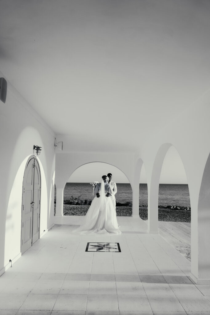 black and white romantic modern wedding photography of bride and groom at Ayia Thekla church near Ayia Napa Cyprus. The best Greek Orthodox island wedding