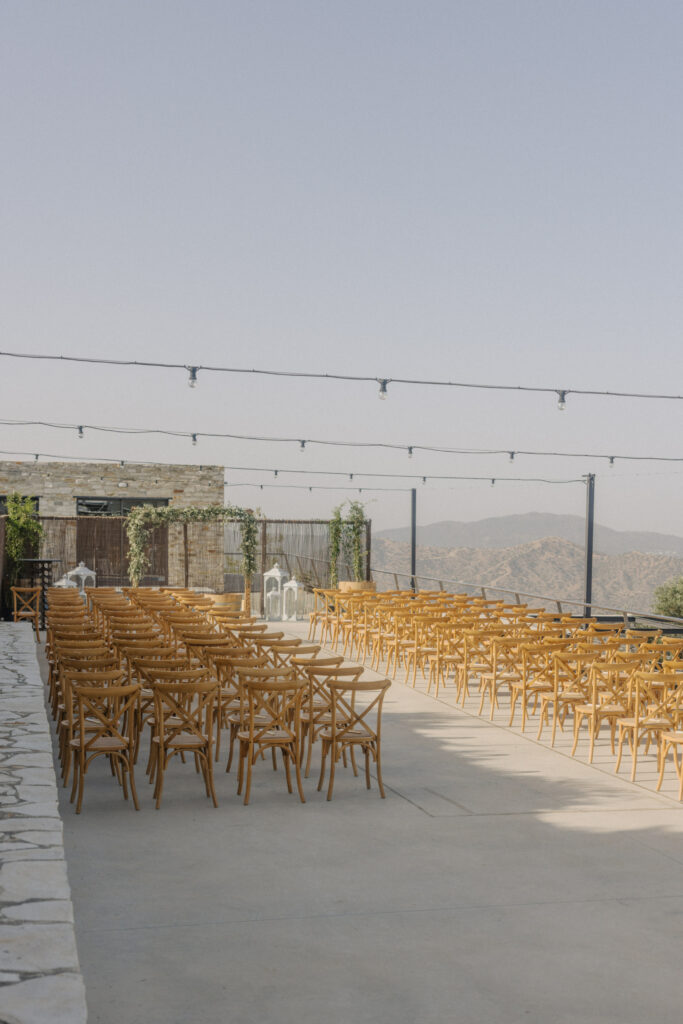 rustic wooden ceremony set up at Dafermou winery in Cyprus featuring floral arch and beautiful mountain views