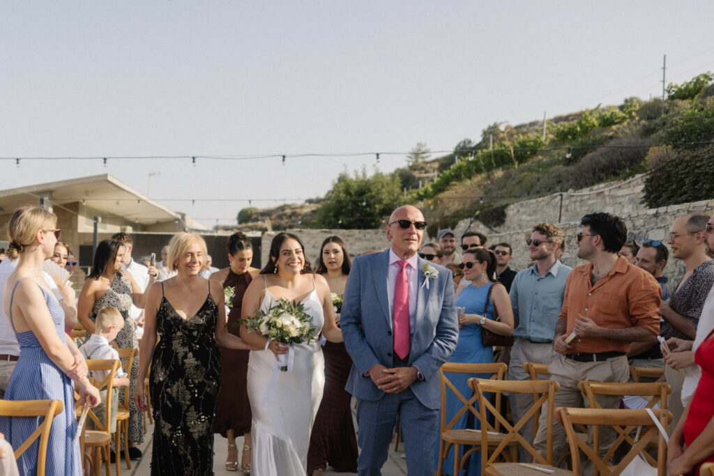 bride entering the ceremony at the wedding at Dafermou winery near Larnaca Cyprus