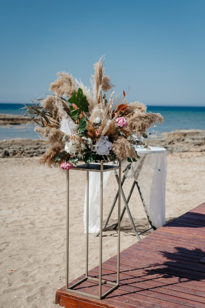 Intimate elopement detail: boho decoration on gold stand at Cyprus beach wedding