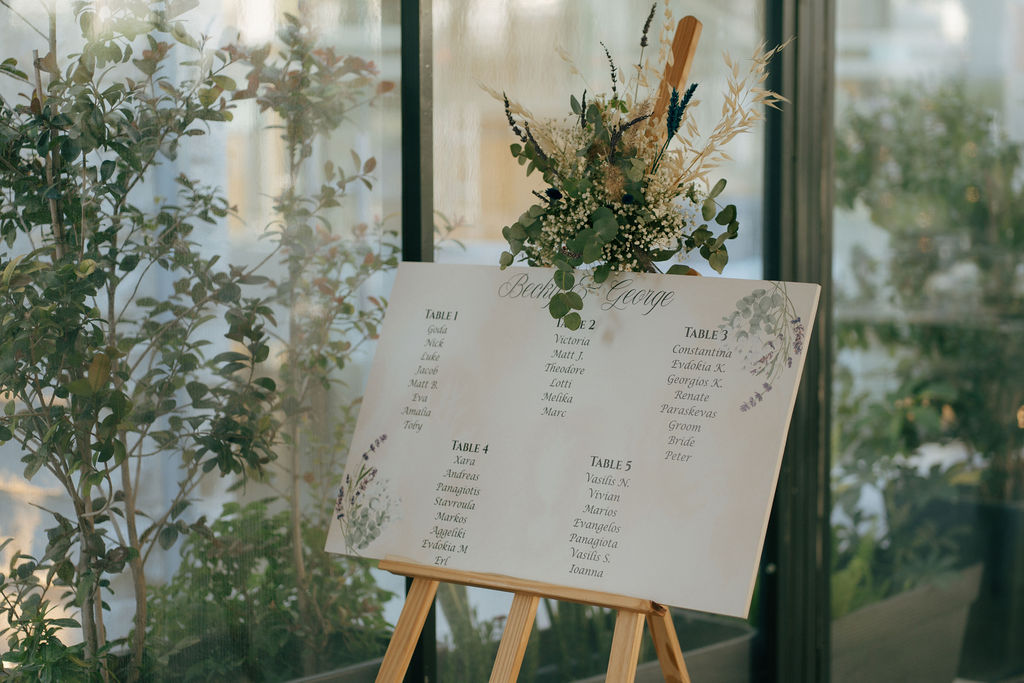 seating plan print at the wooden stand as a part of wedding decoration rental in Cyprus