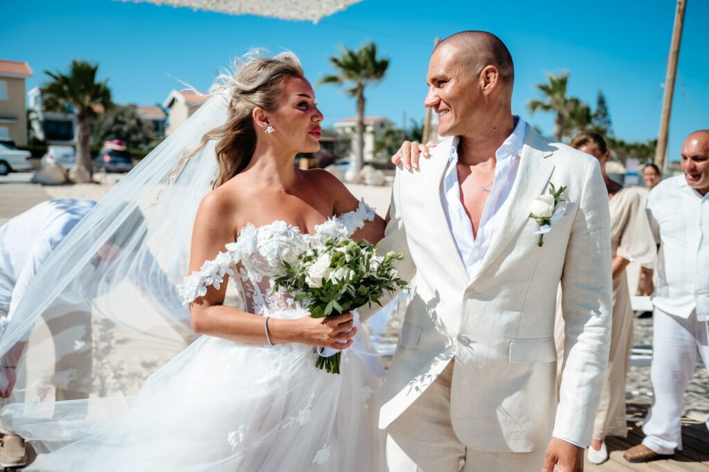 Groom seeing bride for the first time during beach wedding ceremony in Cyprus