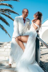 intimate wedding photoshoot of bride and groom standing on the stairs outside of Ayia Thekla chapel