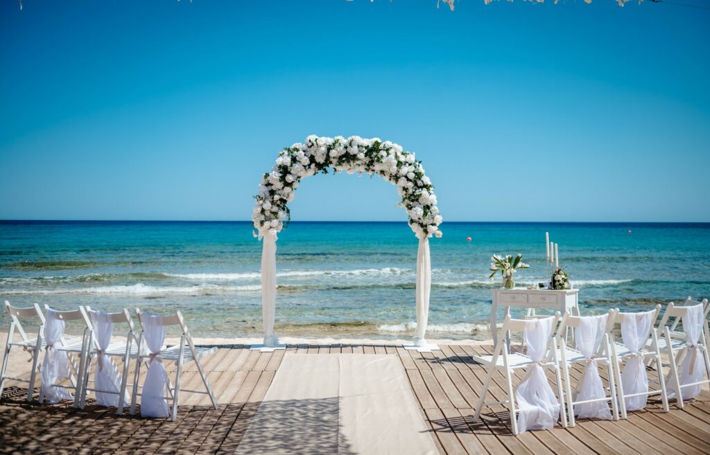 Sirens Beach wedding venue at Ayia Thekla in Cyprus with white and green floral arch