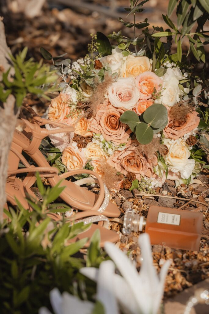 detailed image on the bridal bouquet, perfume and shoes during the wedding in Cyprus