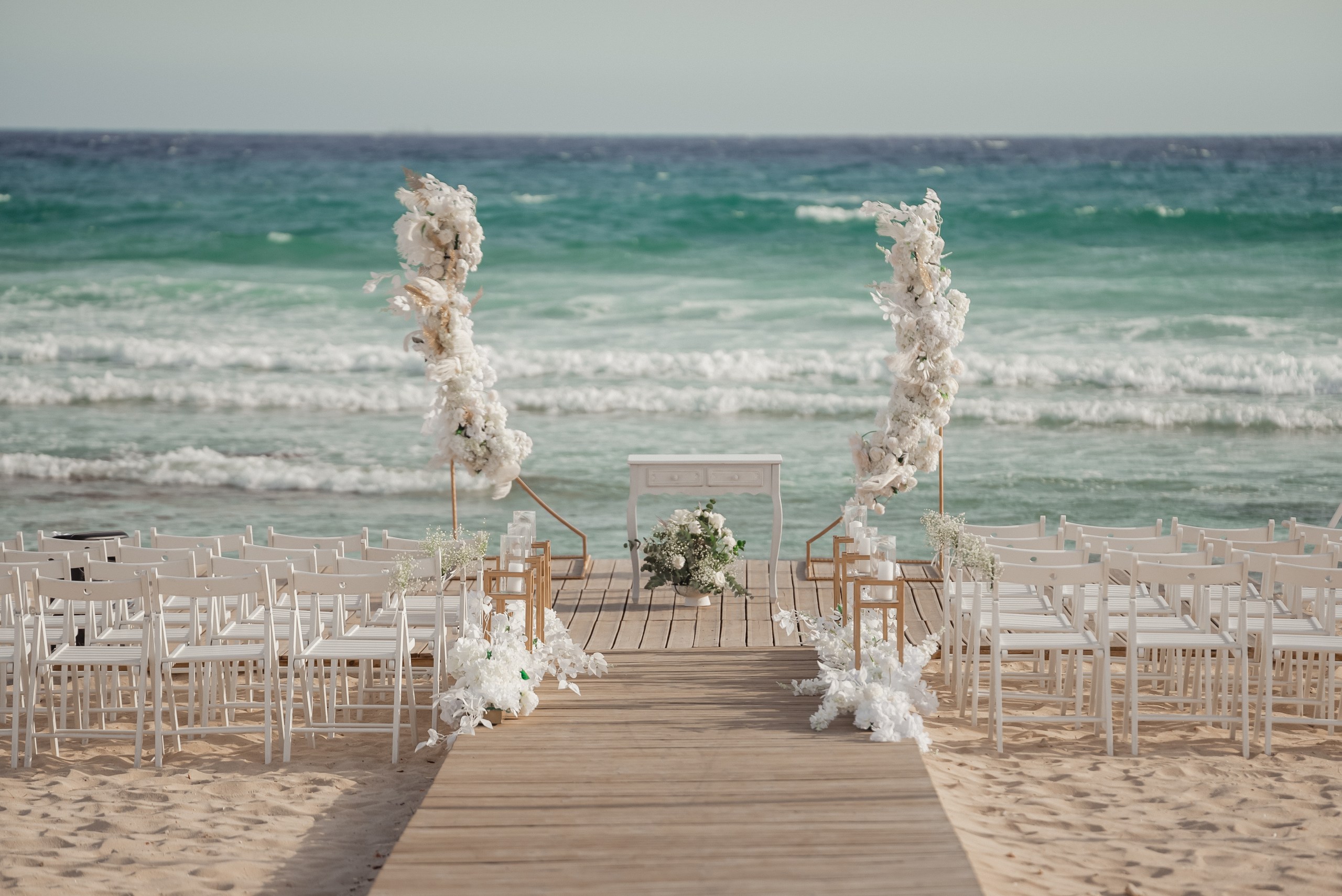 white floral decorations at the beach wedding venue at Sirens beach in Ayia Thekla Cyprus