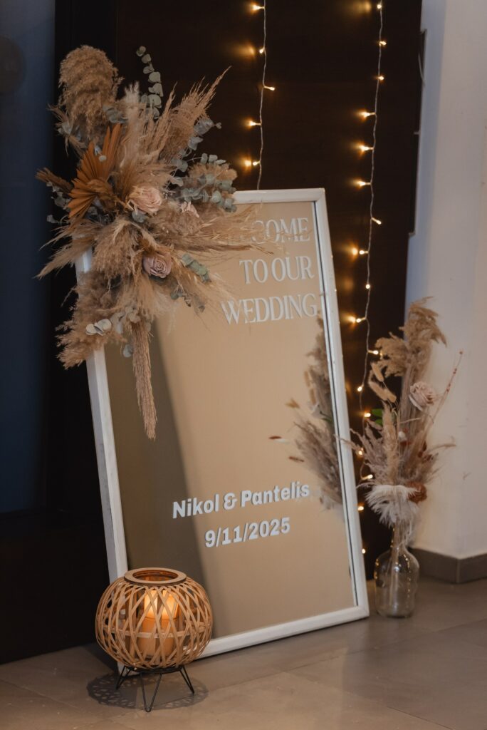 Rustic white mirror wedding welcome sign with boho decorations and lanterns