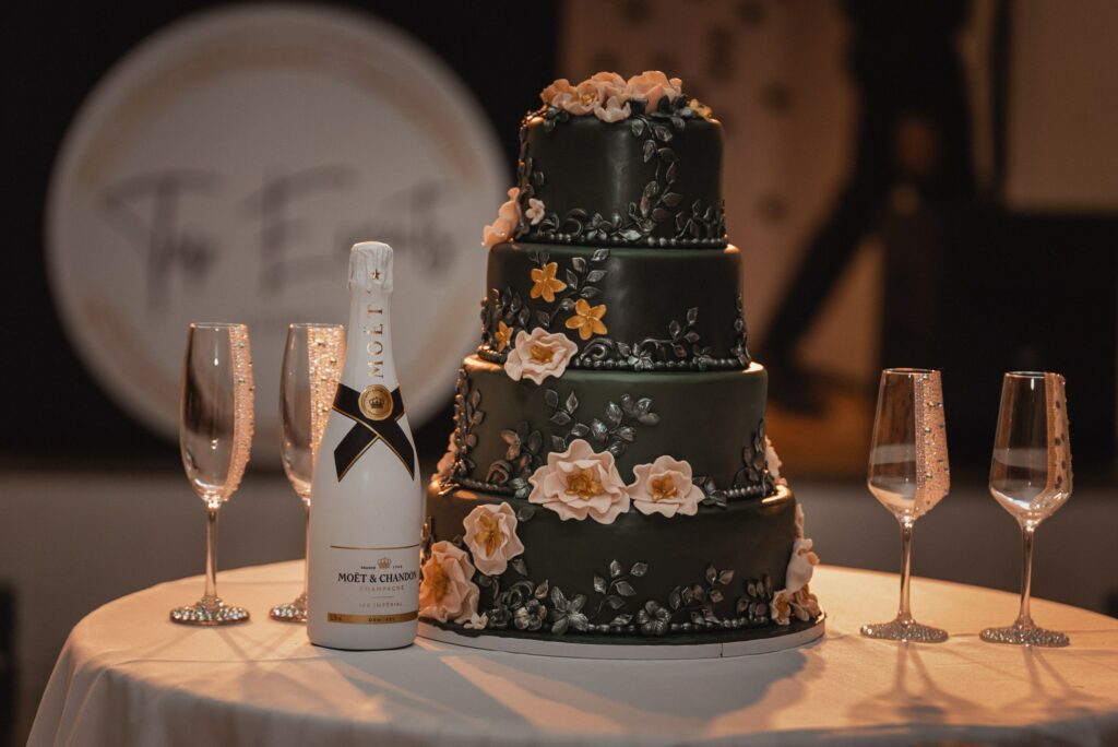 Luxury four tier green floral wedding cake with hand-made crystal champagne glasses in Cyprus