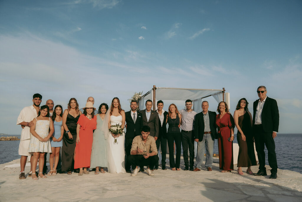 Happy family group photo at wedding ceremony in Cyprus.