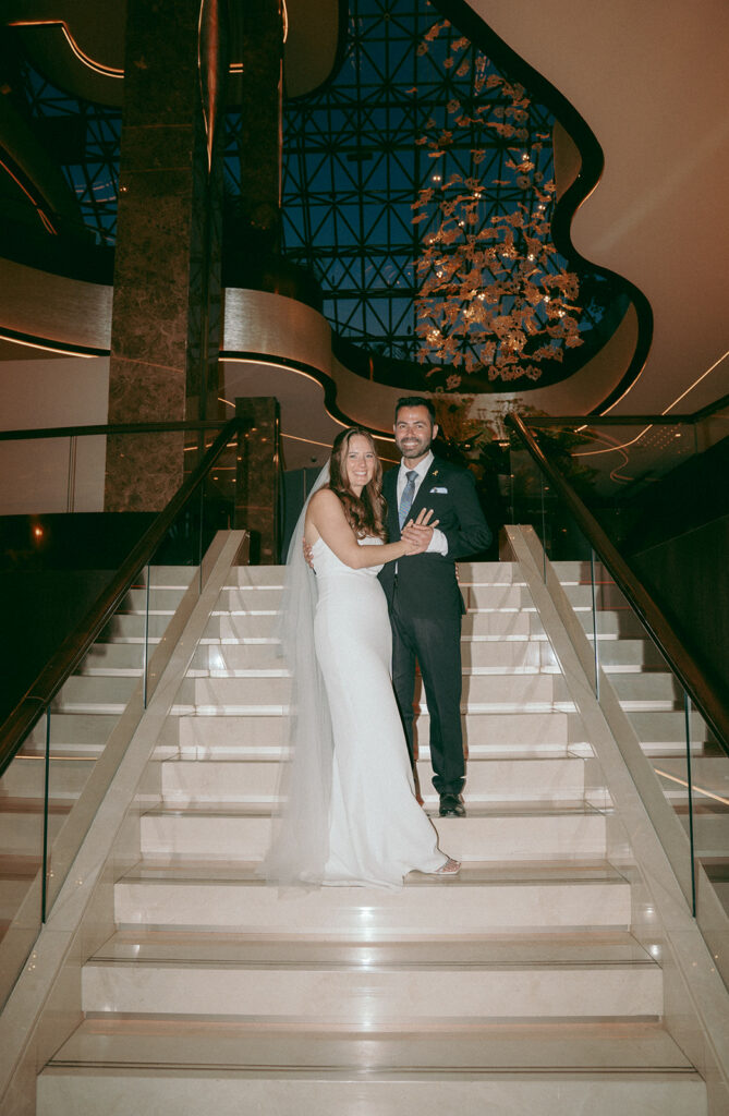 Bride and groom standing on the stairs at Four Seasons hotel in Limassol