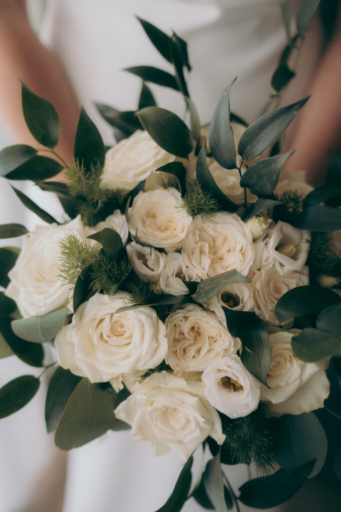 Bridal bouquet made from fresh white roses, eucalyptus and greenery