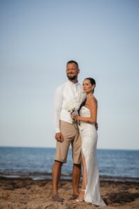 bride and groom standing at the beach of Ayia Triada in Cyprus