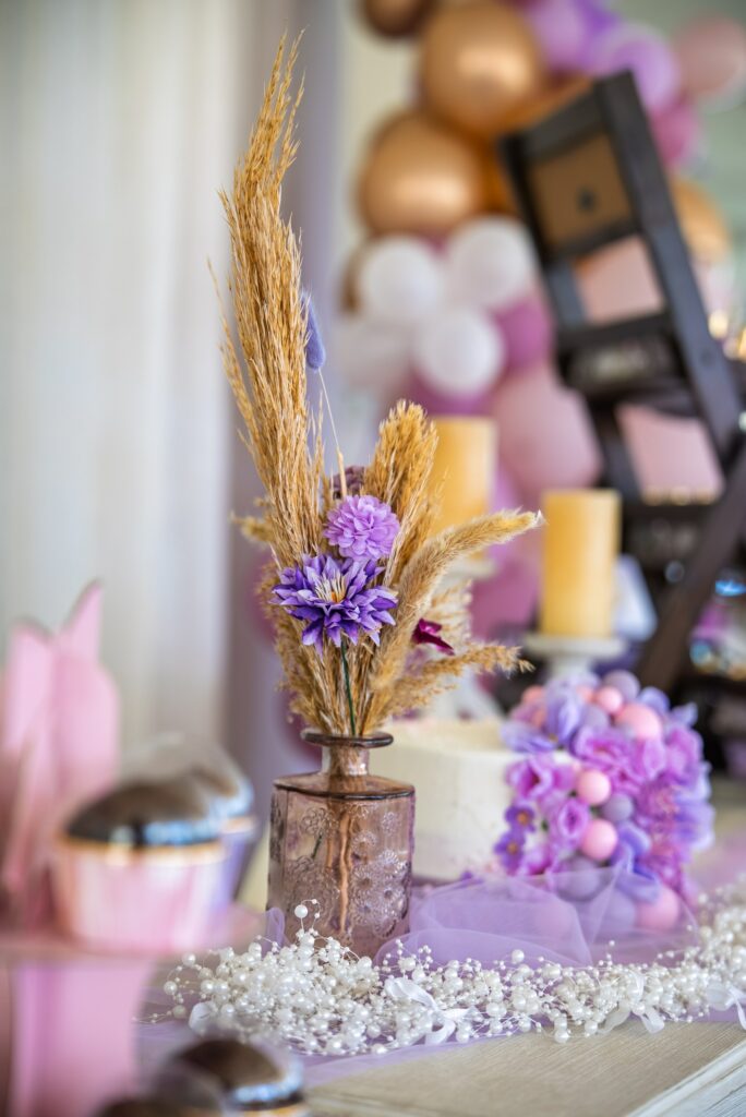 luxury christening decor rentals Nicosia Purple baptism and party table decoration with flowers, cake, and balloon arch backdrop from party and baptism decor rental services in Cyprus.