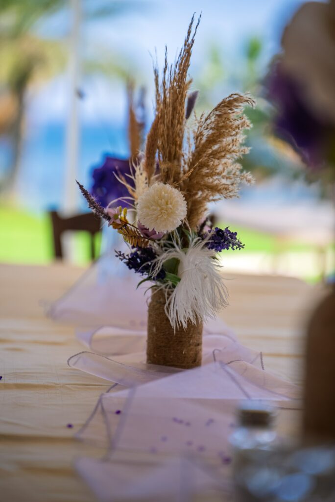 boho purple and white table centerpiece Elegant party and baptism table centerpiece with dried flowers and rustic vase, styled by decor rental services in Cyprus.