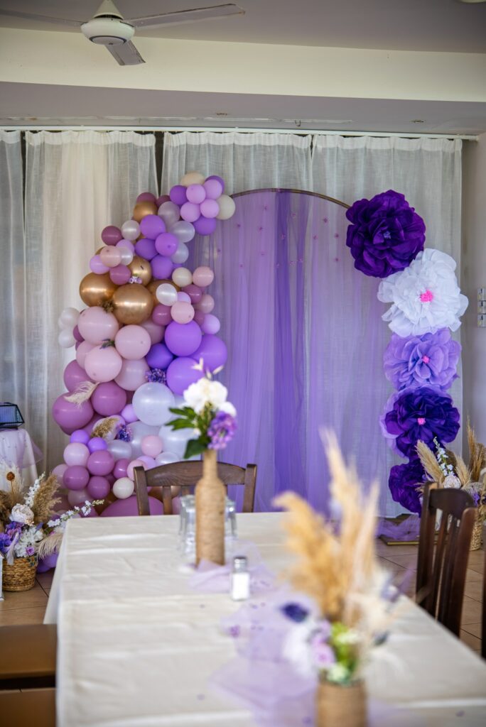 custom made purple balloon arch purple balloon arch with hand made paper flowers and lilac curtains and rustic christening table decor