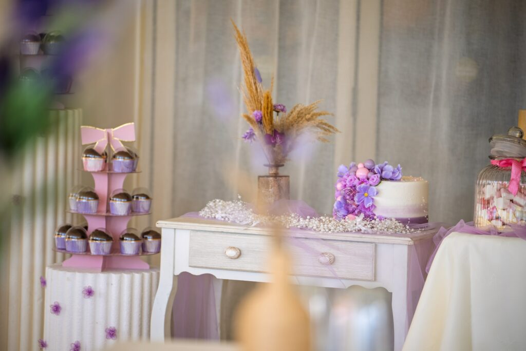 Christening decor Cyprus Elegant baptism dessert table with purple theme, cake, balloon-style decor, and props from decoration rentals in Cyprus.