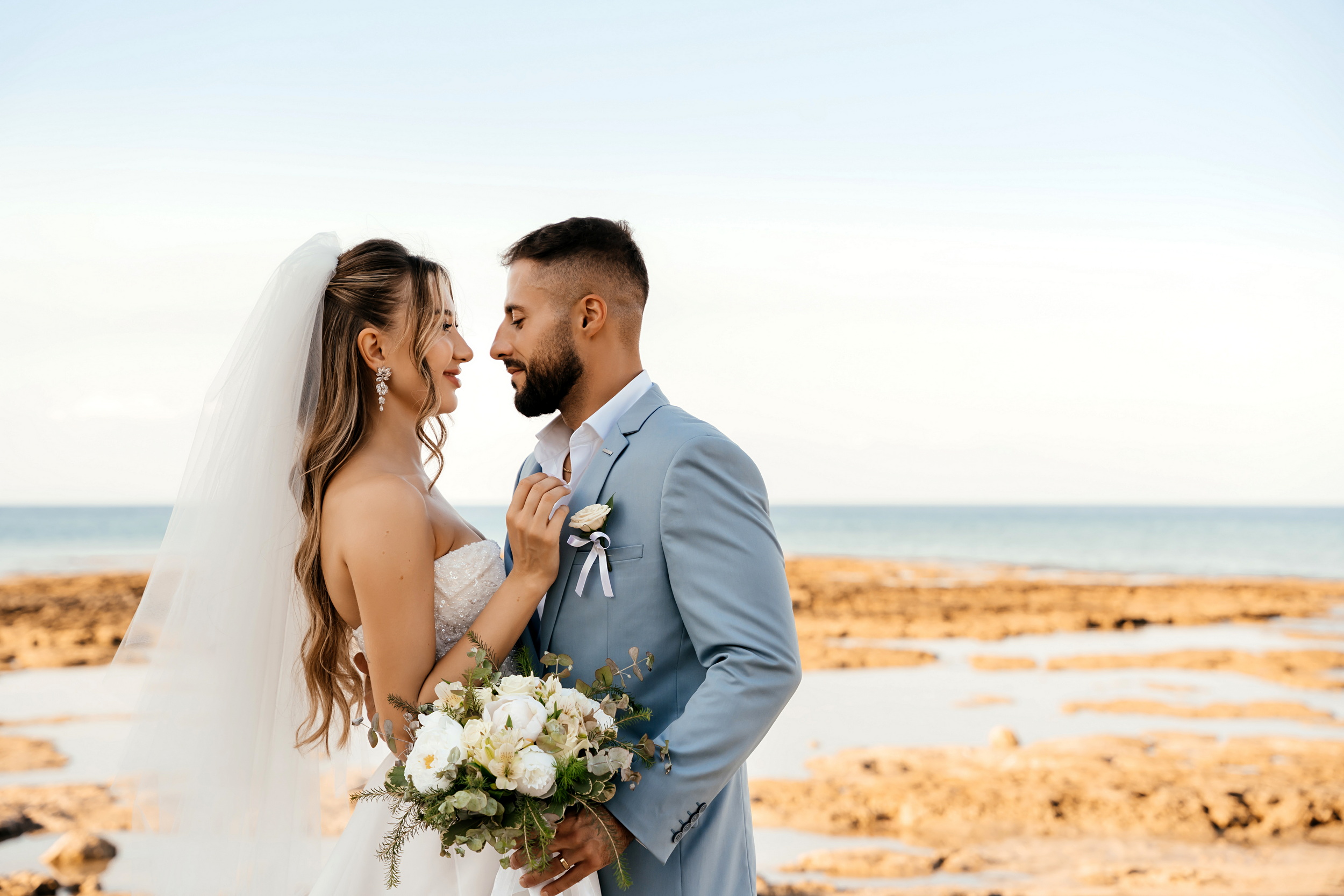 Sunset wedding photography of a couple at Ayia Triada Beach in Protaras, Cyprus, coordinated by a local wedding planner.