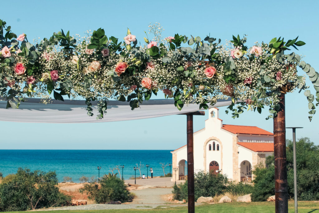Fresh floral wedding arch near the church by Cavo Zoe hotel in Protaras Cyprus