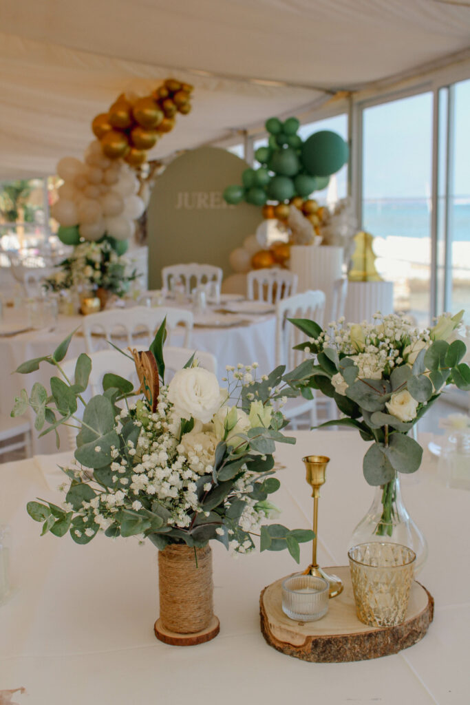 Christening table decoration with green and gold balloons and floral centerpieces for baptism event decor rental in Cyprus