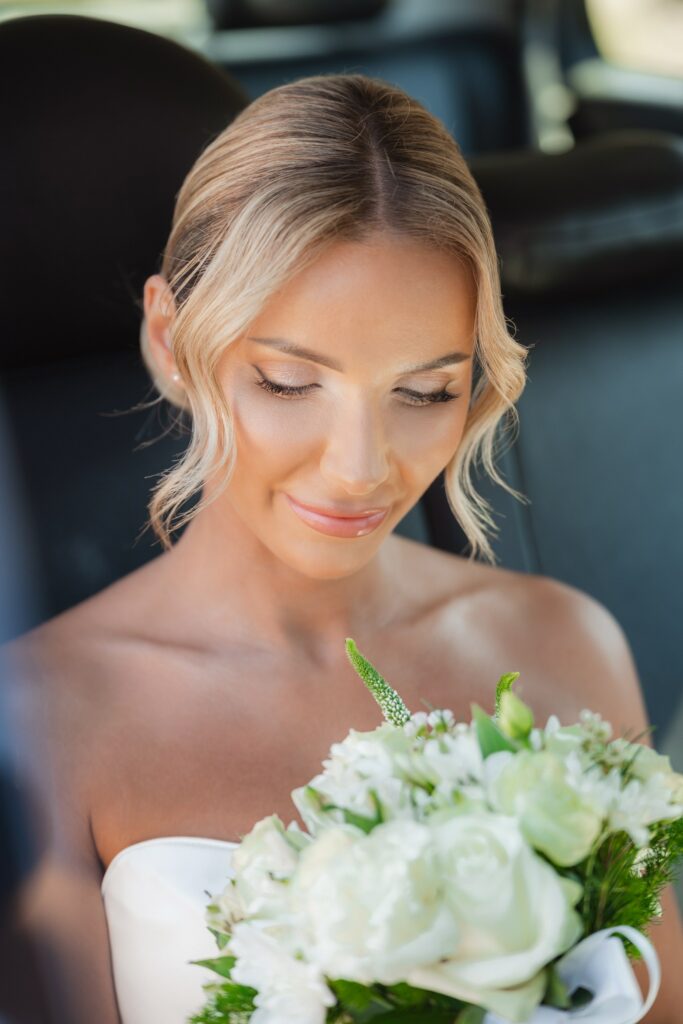 Cyprus bridal wedding photoshoot bride looking at the bouquet
